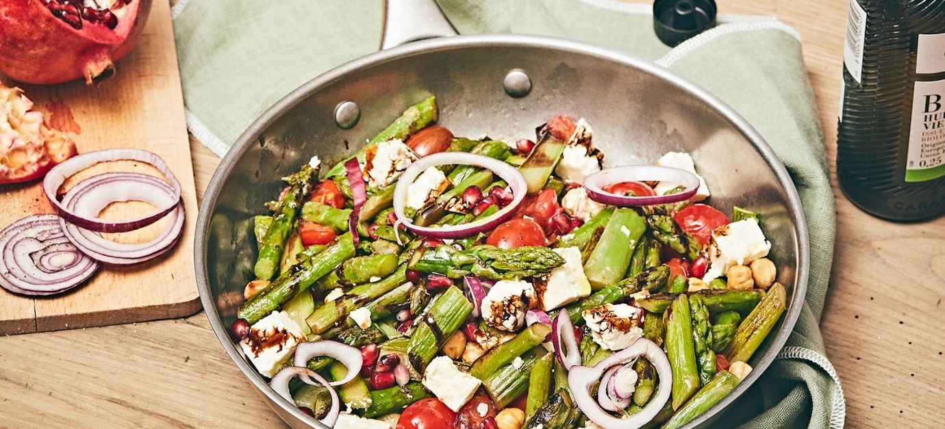 SITRAM recipe for sautéed asparagus with hazelnuts, feta cheese, and pomegranate